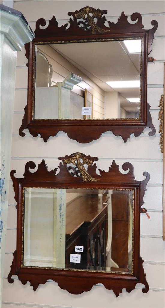 A pair of George III style mahogany fret cut wall mirrors with gilt carved eagle pediments W.58cm